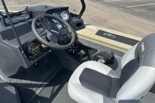 Slide: The Image of 2027 Tracker Targa V-18 Combo boat interior with steering wheel and dashboard controls. - 16