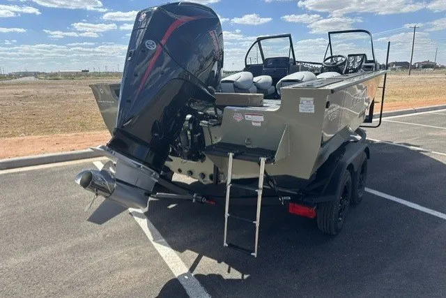 Slide: The Image of 2027 Tracker Targa V-18 Combo boat with powerful outboard motor in a parking lot. - 53