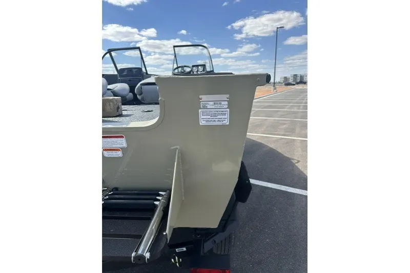 Slide: The Image of 2027 Tracker Targa V-18 Combo boat rear view in parking lot under blue sky. - 54