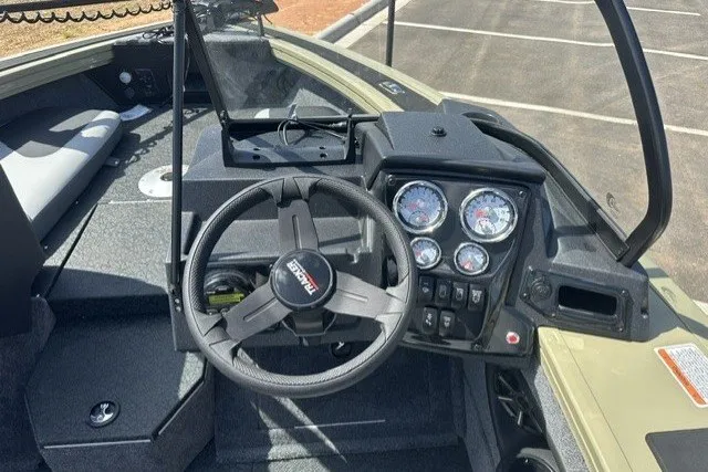 Slide: The Image of 2027 Tracker Targa V-18 Combo boat dashboard with steering wheel and instrument panel. - 15