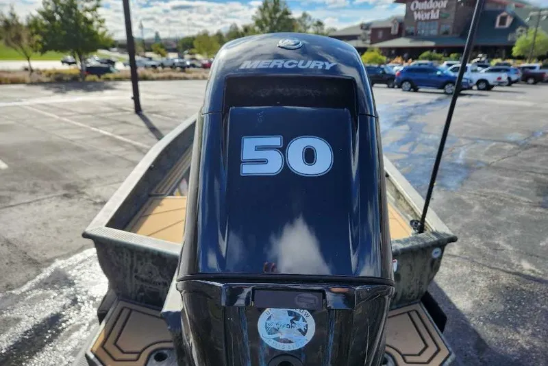 Slide: The Image of 2027 Tracker Grizzly 1654 T Sportsman boat with Mercury 50 horsepower engine in parking lot. - 15