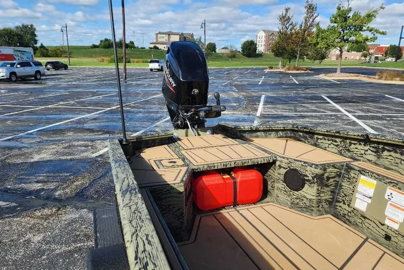 Slide: The Image of Tracker Grizzly 1654 T Sportsman 2027 boat in parking lot with Mercury outboard motor. - 14