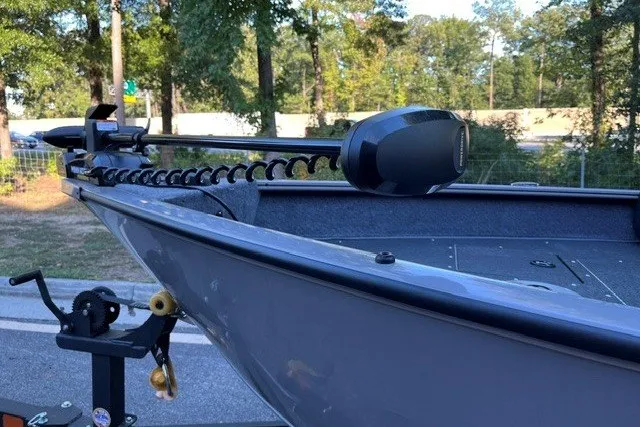 Slide: The Image of 2027 Tracker Pro Guide V-16 WT boat with trolling motor, parked outdoors. - 13