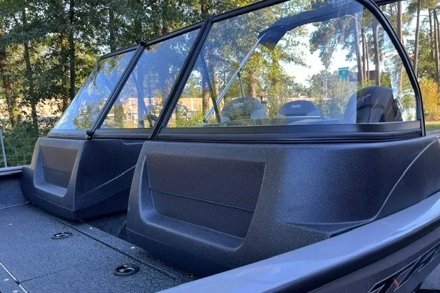 Slide: The Image of 2027 Tracker Pro Guide V-16 WT boat with dual windshields, set against a forested backdrop. - 14