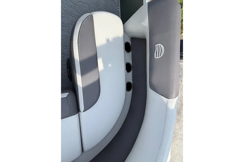 Slide: The Image of 2027 Sun Tracker Bass Buggy 16 XL Select boat seating, featuring gray and white upholstery. - 16