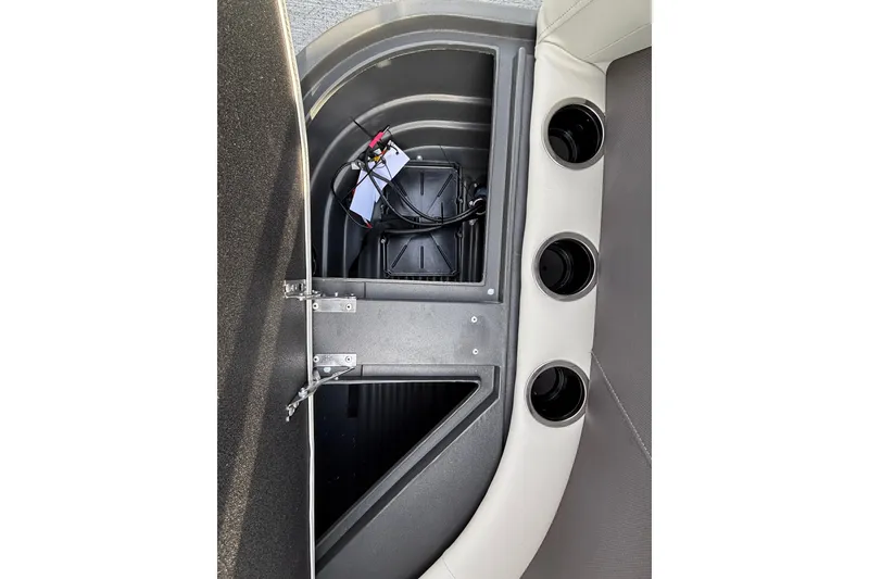 Slide: The Image of 2027 Sun Tracker Bass Buggy 16 XL Select interior storage compartment with cup holders. - 17