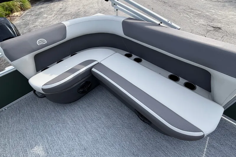 Slide: The Image of 2027 Sun Tracker Bass Buggy 16 XL Select boat seating with cup holders, gray and white upholstery. - 13