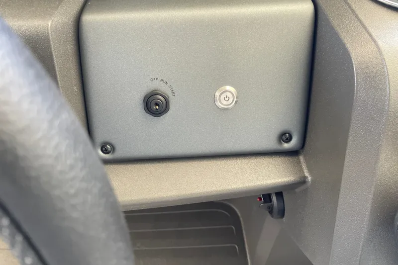 Slide: The Image of Control panel of 2027 Sun Tracker Party Barge 22 DLX with ignition switch and power button. - 32