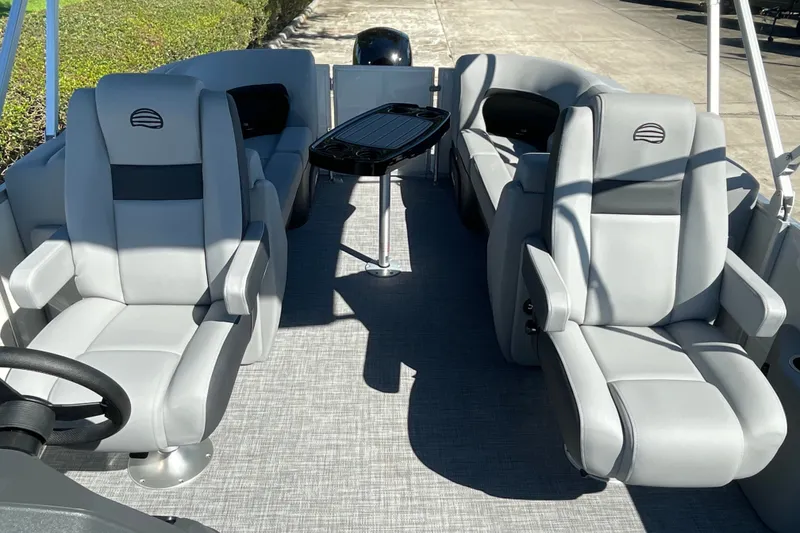 Slide: The Image of 2027 Sun Tracker Party Barge 22 DLX interior with plush seating and sleek design. - 23
