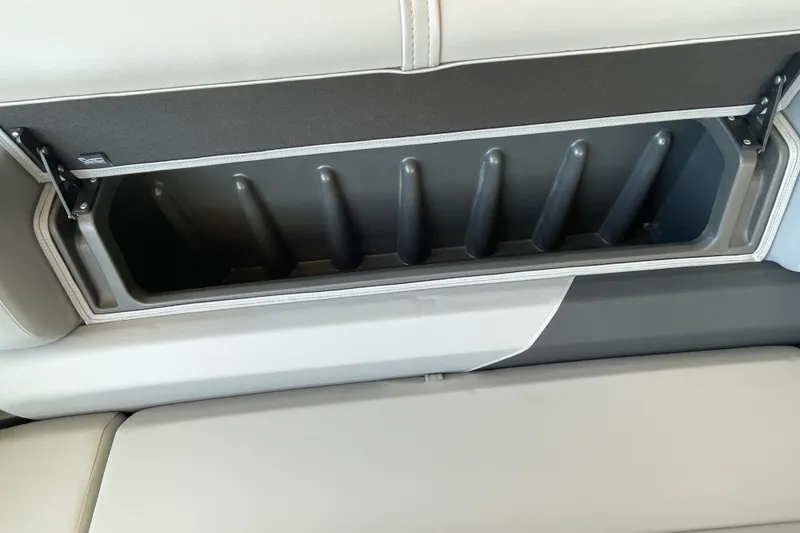 Slide: The Image of Sun Tracker Party Barge 22 DLX 2027 storage compartment with cushioned seating. - 36