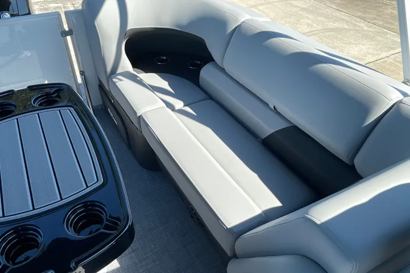 Slide: The Image of 2027 Sun Tracker Party Barge 22 DLX interior with comfortable seating and cup holders. - 15