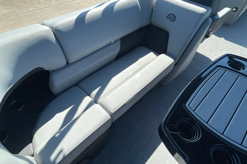 Slide: The Image of 2027 Sun Tracker Party Barge 22 DLX interior with gray seating and black table. - 18
