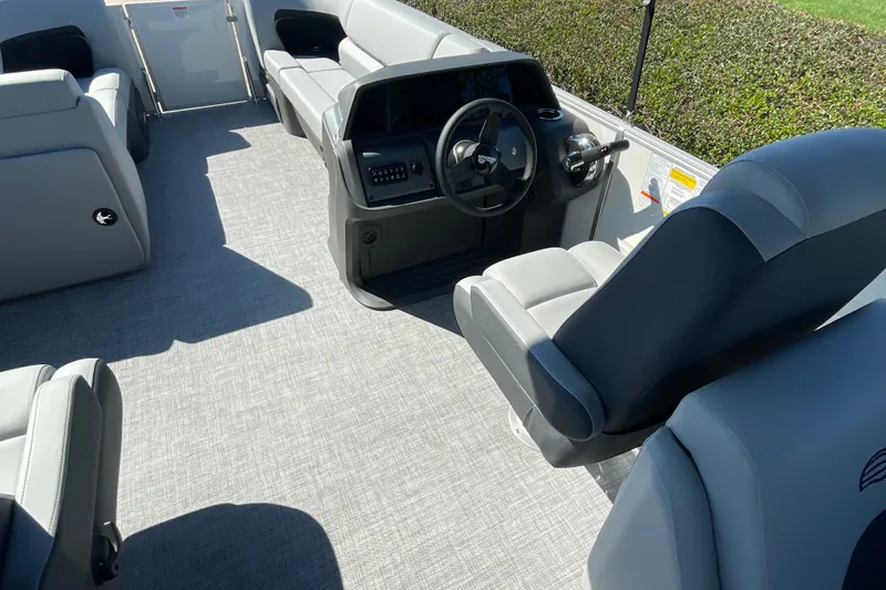 Slide: The Image of 2027 Sun Tracker Party Barge 22 DLX interior with gray seating and steering console. - 20
