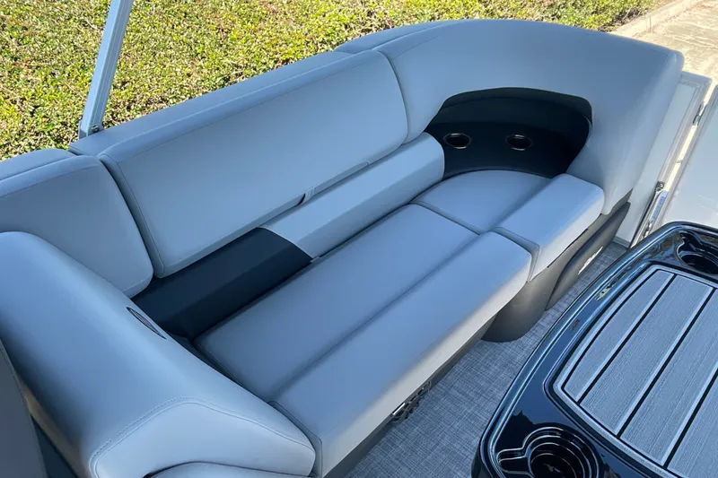 Slide: The Image of Luxurious seating on 2027 Sun Tracker Party Barge 22 DLX with cup holders and sleek design. - 14