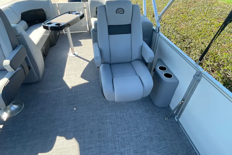 Slide: The Image of Interior of 2027 Sun Tracker Party Barge 22 DLX with comfortable seating and table. - 27
