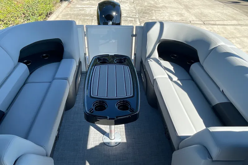 Slide: The Image of 2027 Sun Tracker Party Barge 22 DLX interior with seating and table setup. - 16