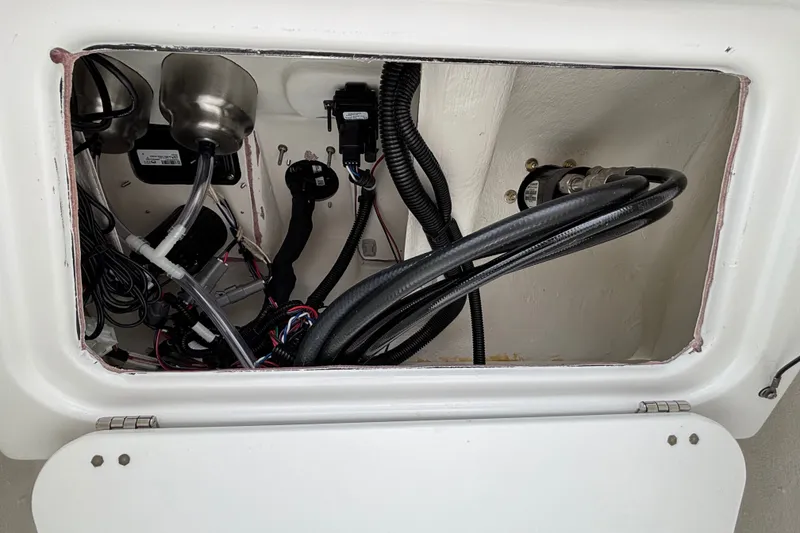 Slide: The Image of 2027 Tahoe 2150 CC boat compartment with wiring and components. - 7