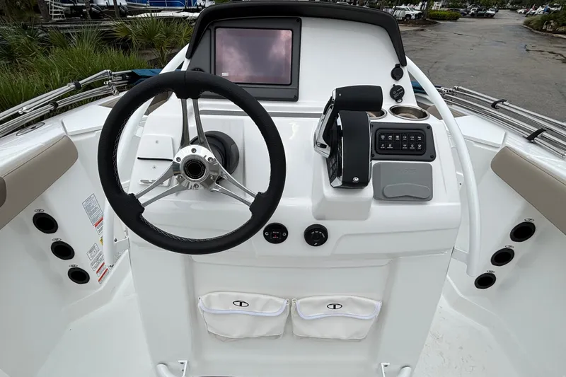 Slide: The Image of 2027 Tahoe 2150 CC boat dashboard with steering wheel and control panel. - 10