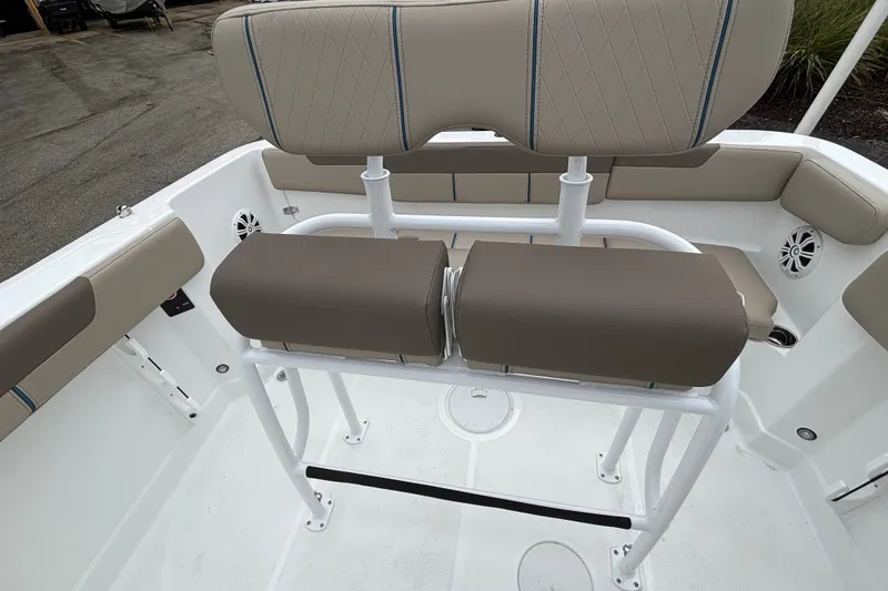 Slide: The Image of 2027 Tahoe 2150 CC boat interior with cushioned seating and white framework. - 9