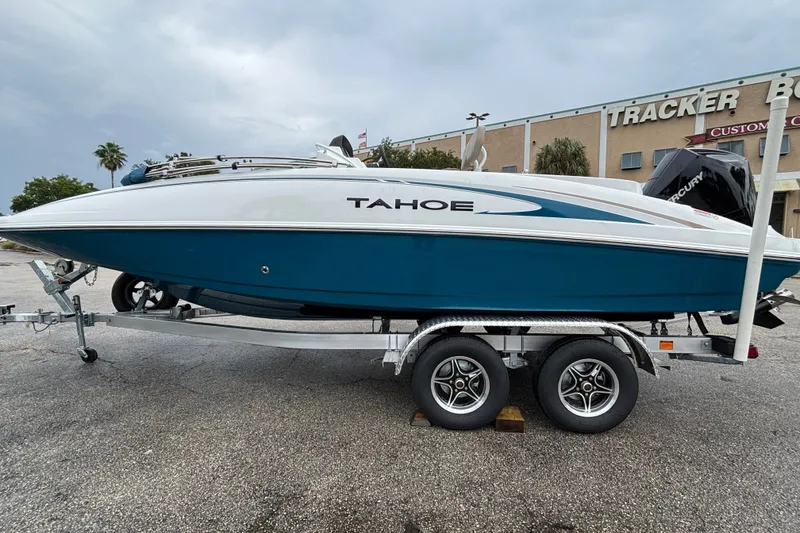 Slide: The Image of 2027 Tahoe 2150 CC boat on trailer, parked outdoors near a building. - 3