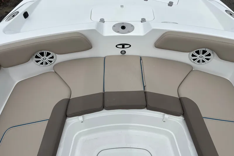 Slide: The Image of Bow seating area of 2027 Tahoe 2150 CC boat with beige cushions and speakers. - 15
