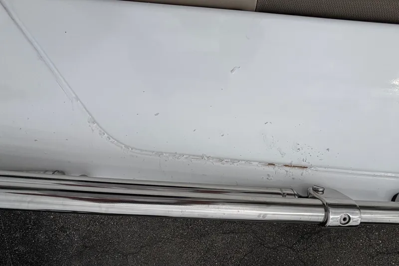 Slide: The Image of Close-up of 2027 Tahoe 2150 CC boat with visible surface scratches. - 127