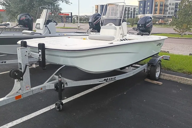 Slide: The Image of 2026 Mako Pro Skiff 13 CC boat on trailer in parking lot. - 1