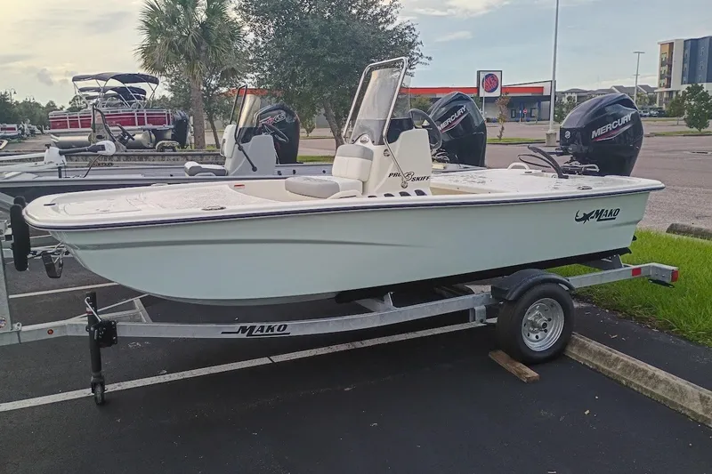 Slide: The Image of 2026 Mako Pro Skiff 13 CC boat on trailer in parking lot. - 2