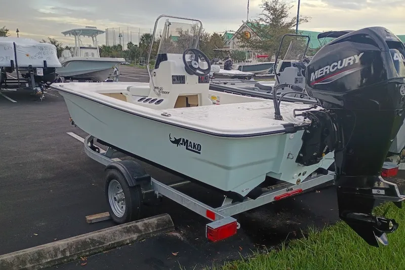 Slide: The Image of 2026 Mako Pro Skiff 13 CC boat on trailer with Mercury outboard motor. - 3