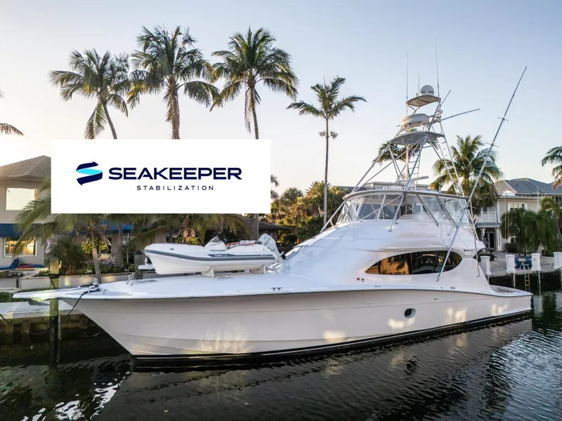 The Image of 2008 Hatteras 68 Convertible yacht with Seakeeper stabilization, docked near palm trees. - 0