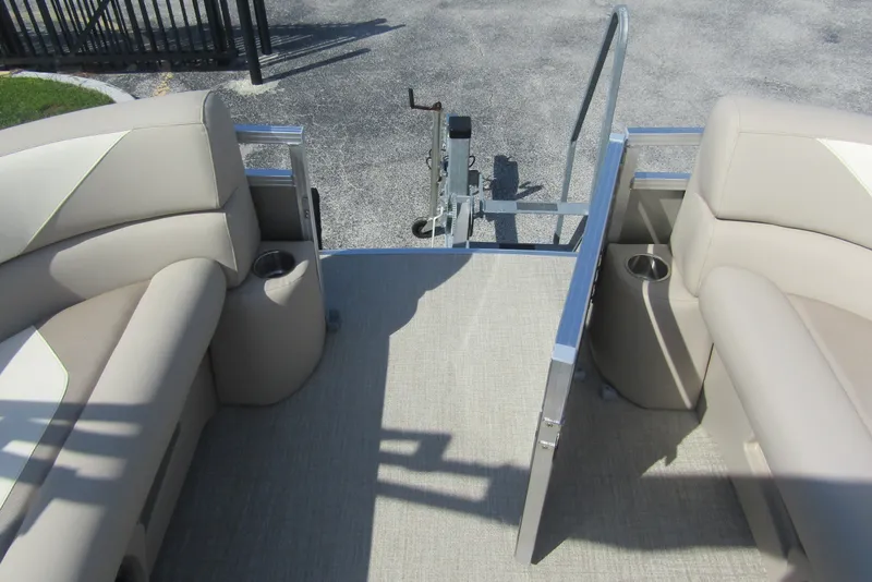 Slide: The Image of 2026 Tahoe Pontoon Sport 85 Rear Fish 21 interior with beige seating and cup holders. - 10