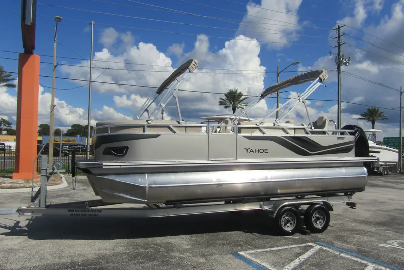 Slide: The Image of 2026 Tahoe Pontoon Sport 85 Rear Fish 21 on trailer, under blue sky. - 6