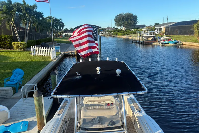 Slide: The Image of 2010 Key West 244 Center Console boat docked in a scenic canal setting. - 25