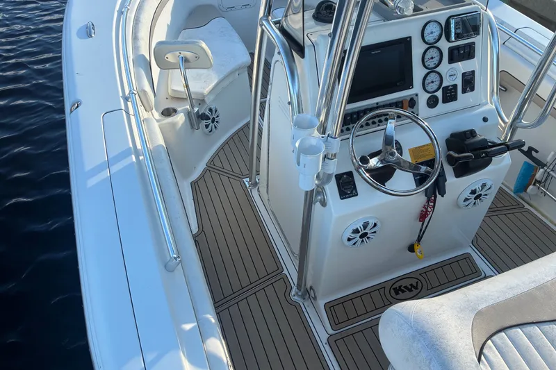 Slide: The Image of 2010 Key West 244 Center Console boat interior with steering wheel and control panel. - 24