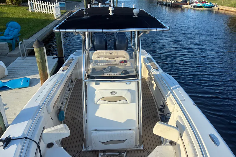 Slide: The Image of 2010 Key West 244 Center Console boat docked by a canal. - 26