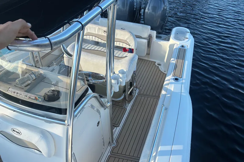 Slide: The Image of 2010 Key West 244 Center Console boat interior with seating and controls on water. - 19