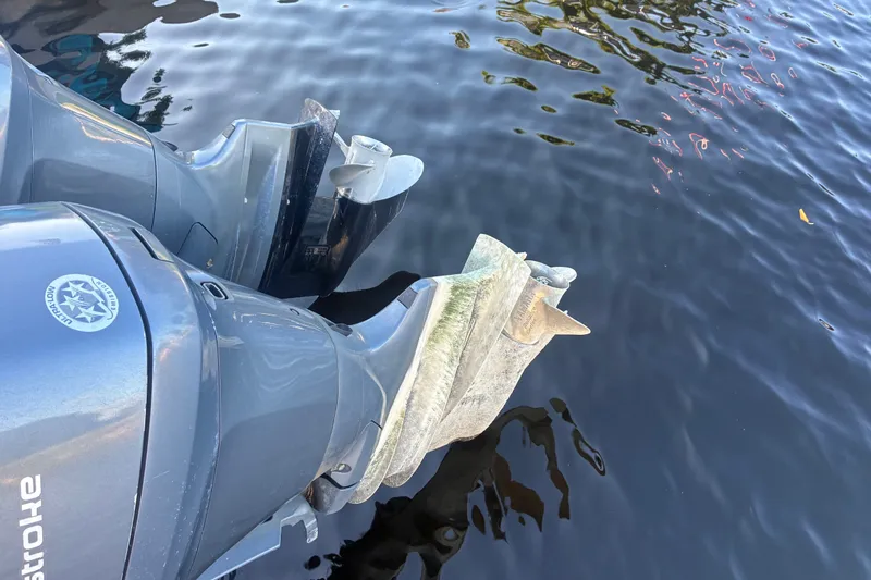 Slide: The Image of Twin outboard motors on a 2010 Key West 244 Center Console boat in water. - 30