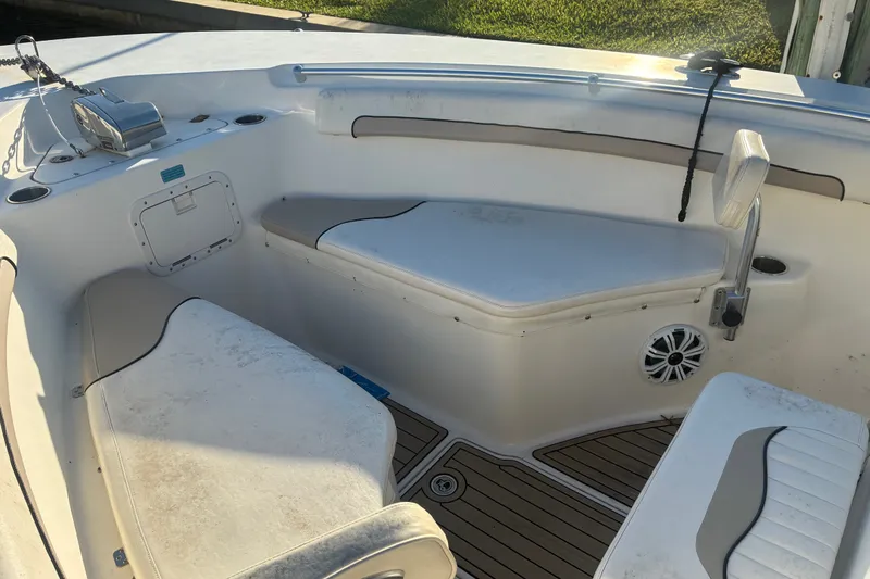 Slide: The Image of 2010 Key West 244 Center Console boat interior with seating and storage. - 2