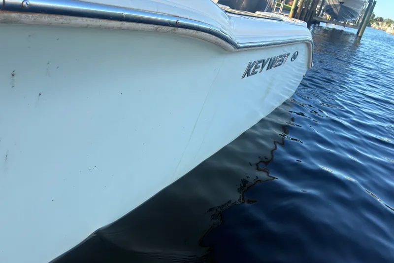 Slide: The Image of 2010 Key West 244 Center Console boat on calm water. - 49