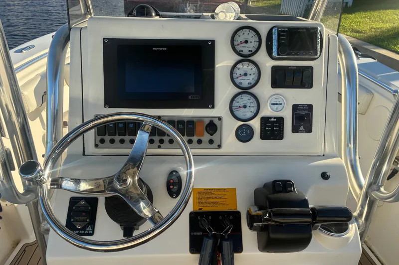 Slide: The Image of Center console dashboard of 2010 Key West 244 boat with steering wheel and gauges. - 17