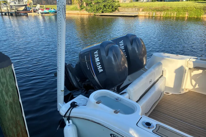 Slide: The Image of 2010 Key West 244 Center Console boat with Yamaha engines docked by the water. - 31