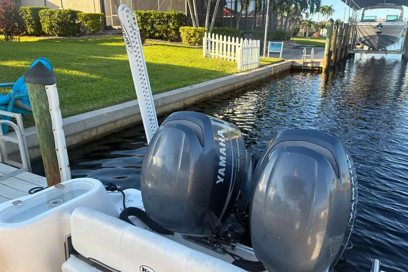 Slide: The Image of 2010 Key West 244 Center Console with Yamaha engines docked by a canal. - 28