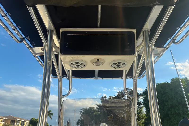 Slide: The Image of T-top view of 2010 Key West 244 Center Console boat with speakers and clear sky. - 44