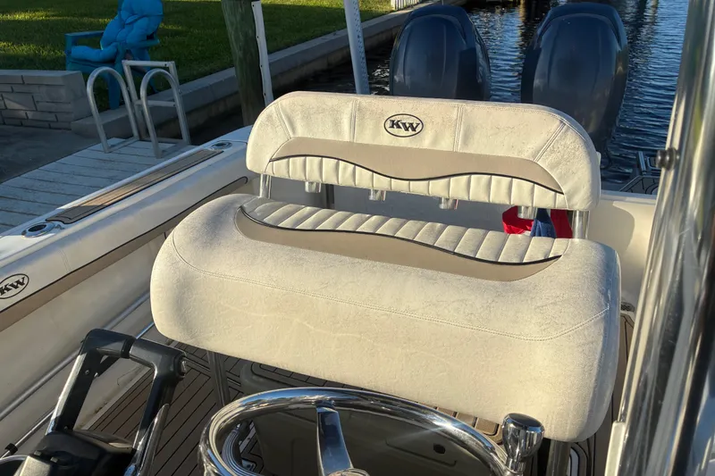 Slide: The Image of 2010 Key West 244 Center Console boat interior with dual engines and cushioned seating. - 20