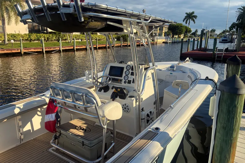 Slide: The Image of 2010 Key West 244 Center Console boat docked by a scenic waterfront. - 8