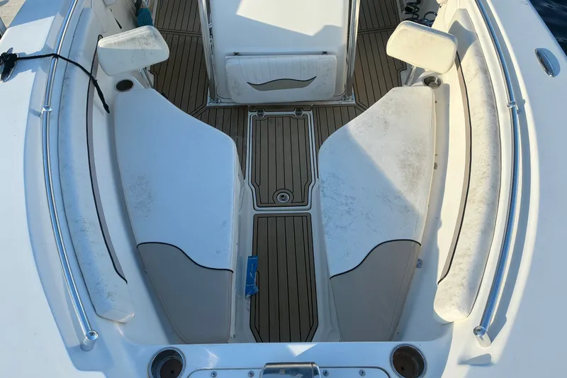 Slide: The Image of 2010 Key West 244 Center Console boat interior with seating and teak flooring. - 7