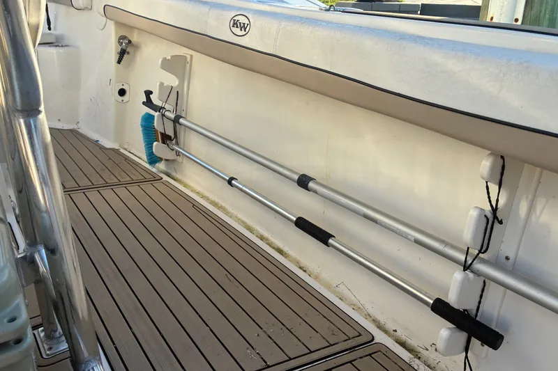 Slide: The Image of 2010 Key West 244 Center Console boat deck with cleaning tools stored securely. - 40