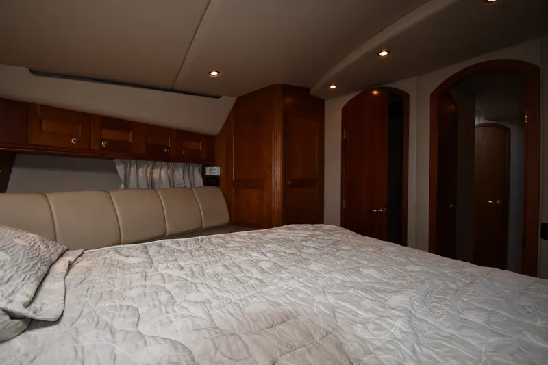 Slide: The Image of Luxurious bedroom interior of 2003 Cruisers Yachts 5000 Sedan Sport with elegant wood finishes. - 41