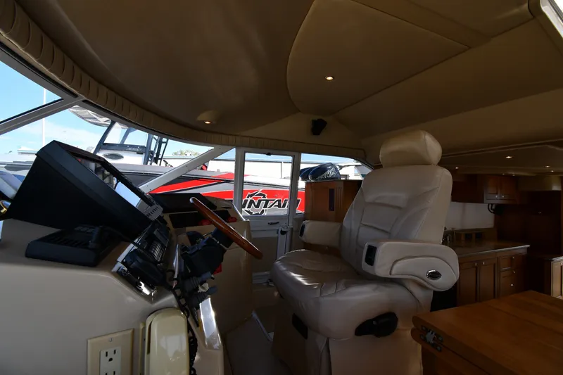 Slide: The Image of Interior of 2003 Cruisers Yachts 5000 Sedan Sport, featuring captain's chair and control panel. - 75