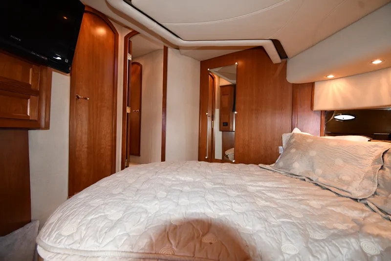 Slide: The Image of Luxurious cabin interior of 2003 Cruisers Yachts 5000 Sedan Sport with cozy bedding. - 48